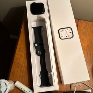 Apple Watch. 4.5mm x 3.5mm. Black case, black band. Charger included.